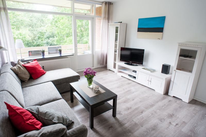 't Kerckeland - Apartment Kerckeland 92, De Koog: Spacious living room with lots of natural light and access to balcony.