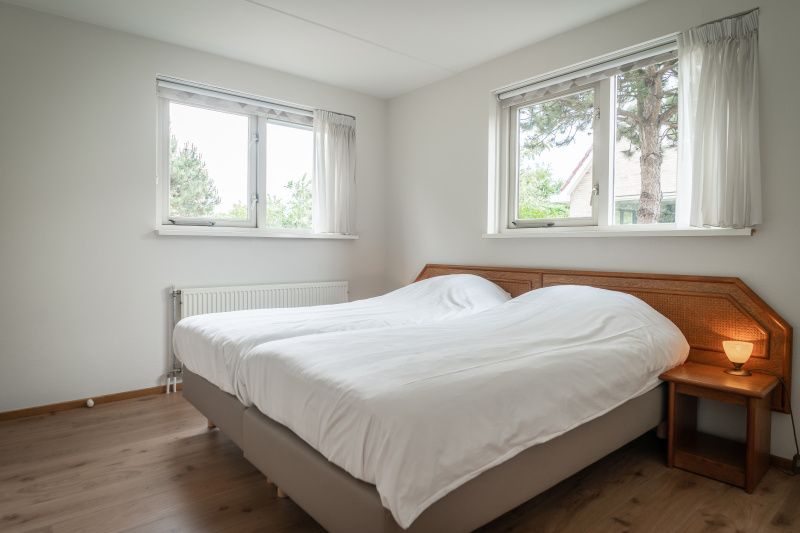 Bedroom in Villa 304, De Koog, Texel with comfortable double bed and lots of natural light.