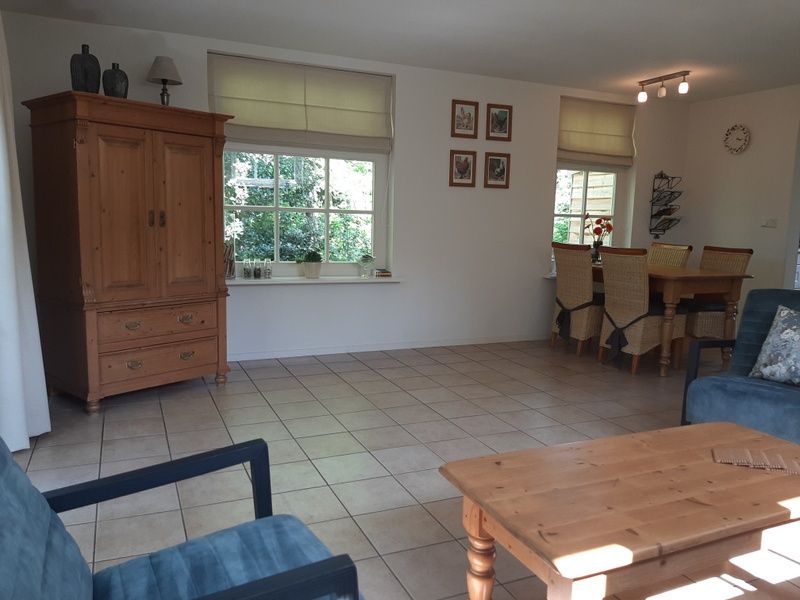 Spacious dining room in Pauwenhof Texel vacation home in De Koog with lots of natural light.