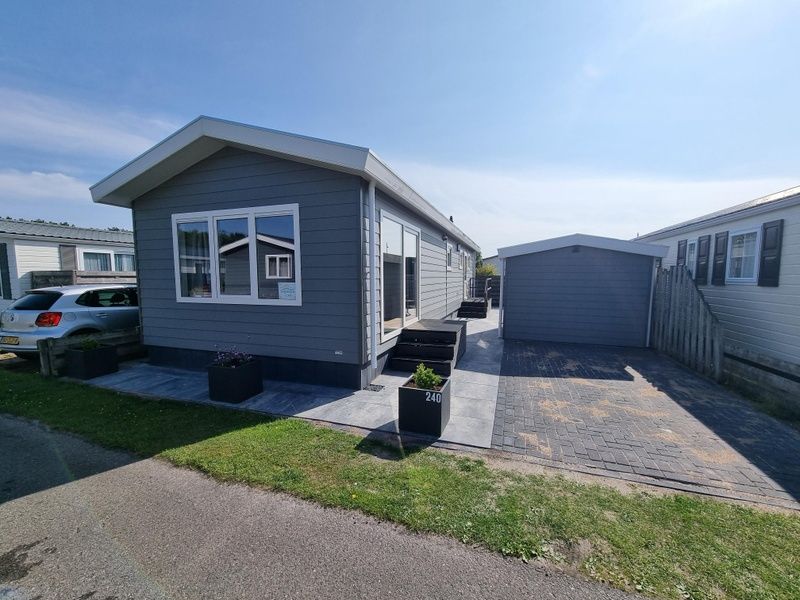 Exterior of Chaletpark Bregkoog - Chalet 240 De Texelse Berg in De Koog, Texel, with spacious driveway and modern look.