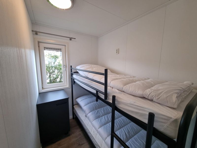 Cozy bedroom with bunk beds in Chaletpark Bregkoog - Chalet 240 De Texelse Berg, De Koog, Texel.