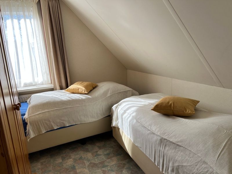 Bedroom with two single beds in Landgoed Springtij - Koetshuis 2, vacation home in De Koog, Texel, ideal for families.