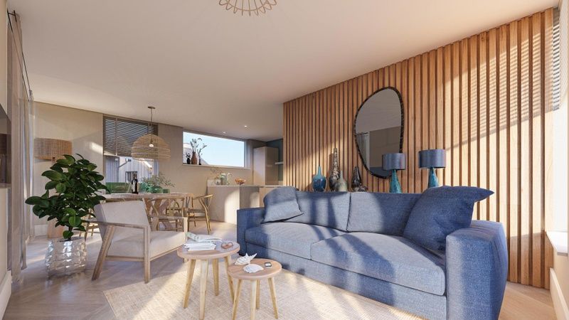 Bright living room in Duinvilla Wellness 6, Texel, with comfortable sofa and wooden wall decoration.