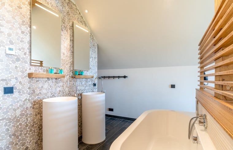 Modern bathroom with double sinks in Holiday home in De Koog Texel, offers comfort on the Wadden Islands.