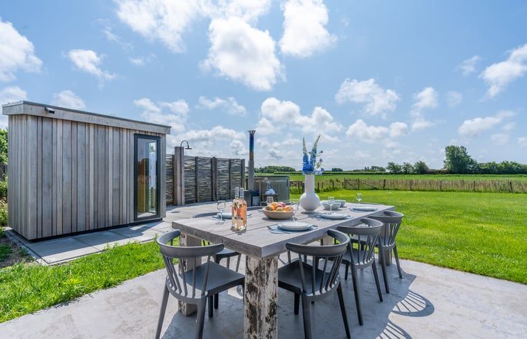 Outdoor dining area overlooking nature in Holiday home in De Koog Texel, perfect for dining on the Wadden Islands.