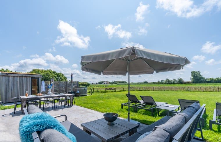 Terrace with comfortable seating and views of nature in Holiday home in De Koog Texel, for relaxation on the Wadden Islands.