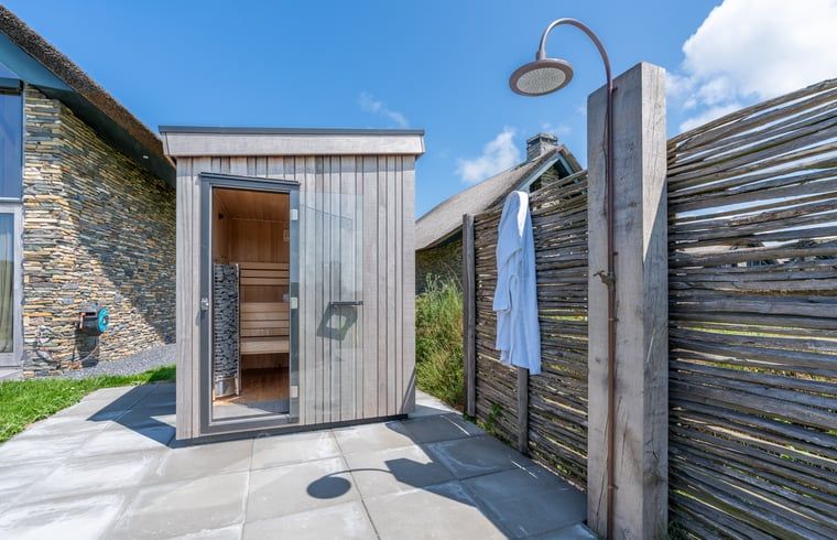 External sauna with outdoor shower in Holiday home in De Koog Texel, for a wellness experience on the Wadden Islands.