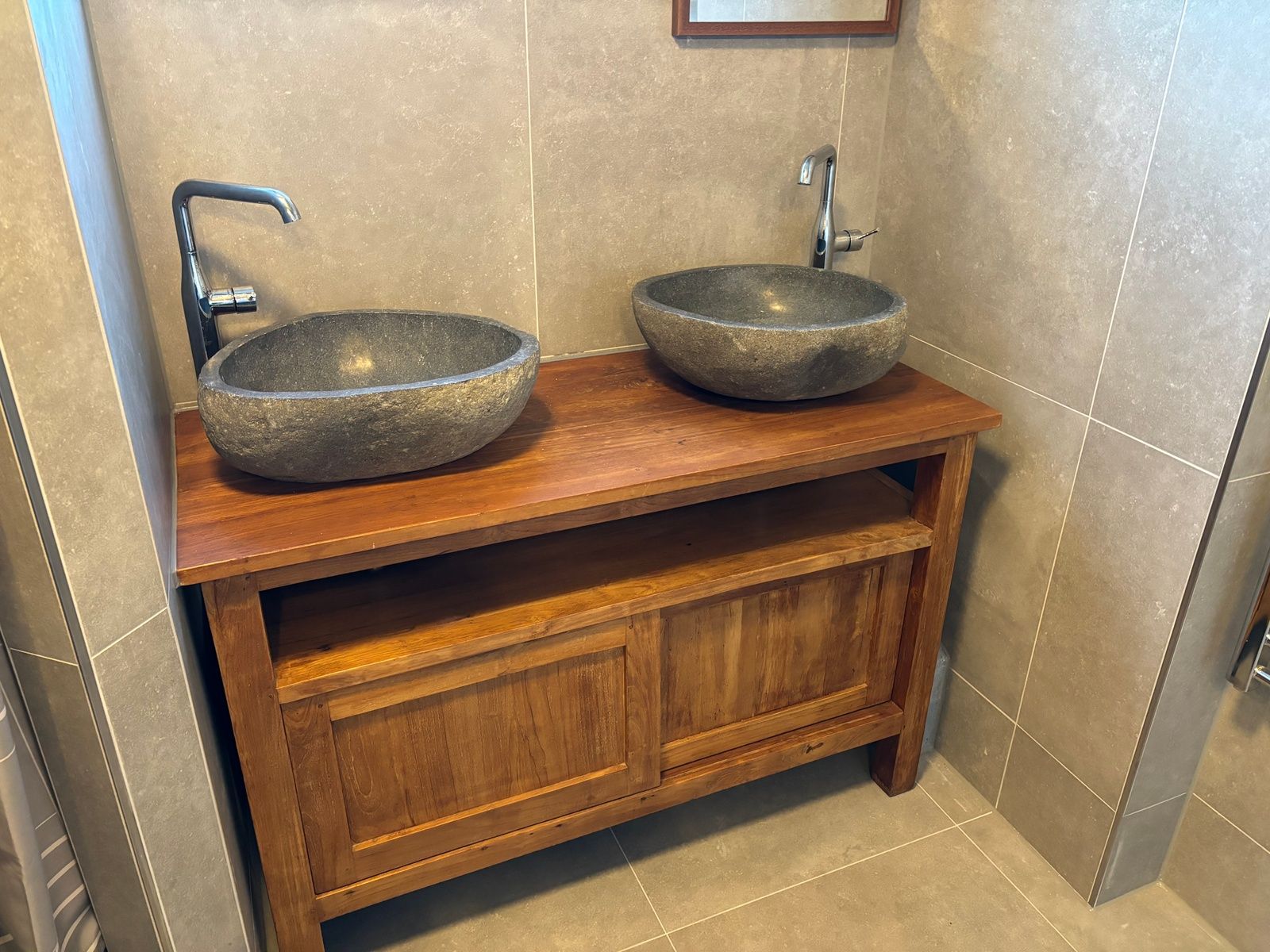 Double sink in bathroom of Stormvogel, vacation home De Koog, Texel with wooden furniture.