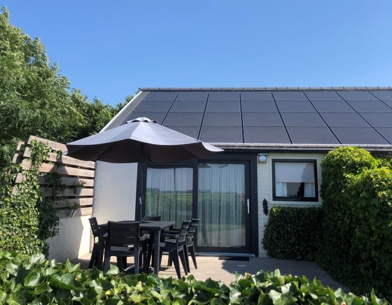 Sunny terrace of Bungalow 2 in De Koog, Texel, ideal for relaxing in nature.