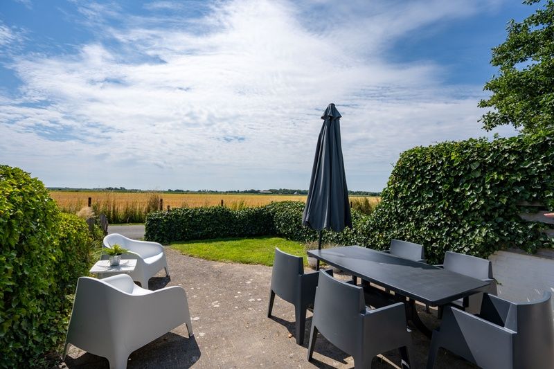 Beautiful view from the terrace of Bungalow 2 in De Koog, Texel, with vast fields.