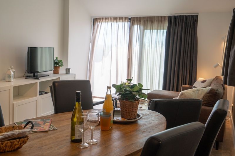 Cozy dining area in Bungalow 2, De Koog, Texel, overlooking the terrace and natural light.