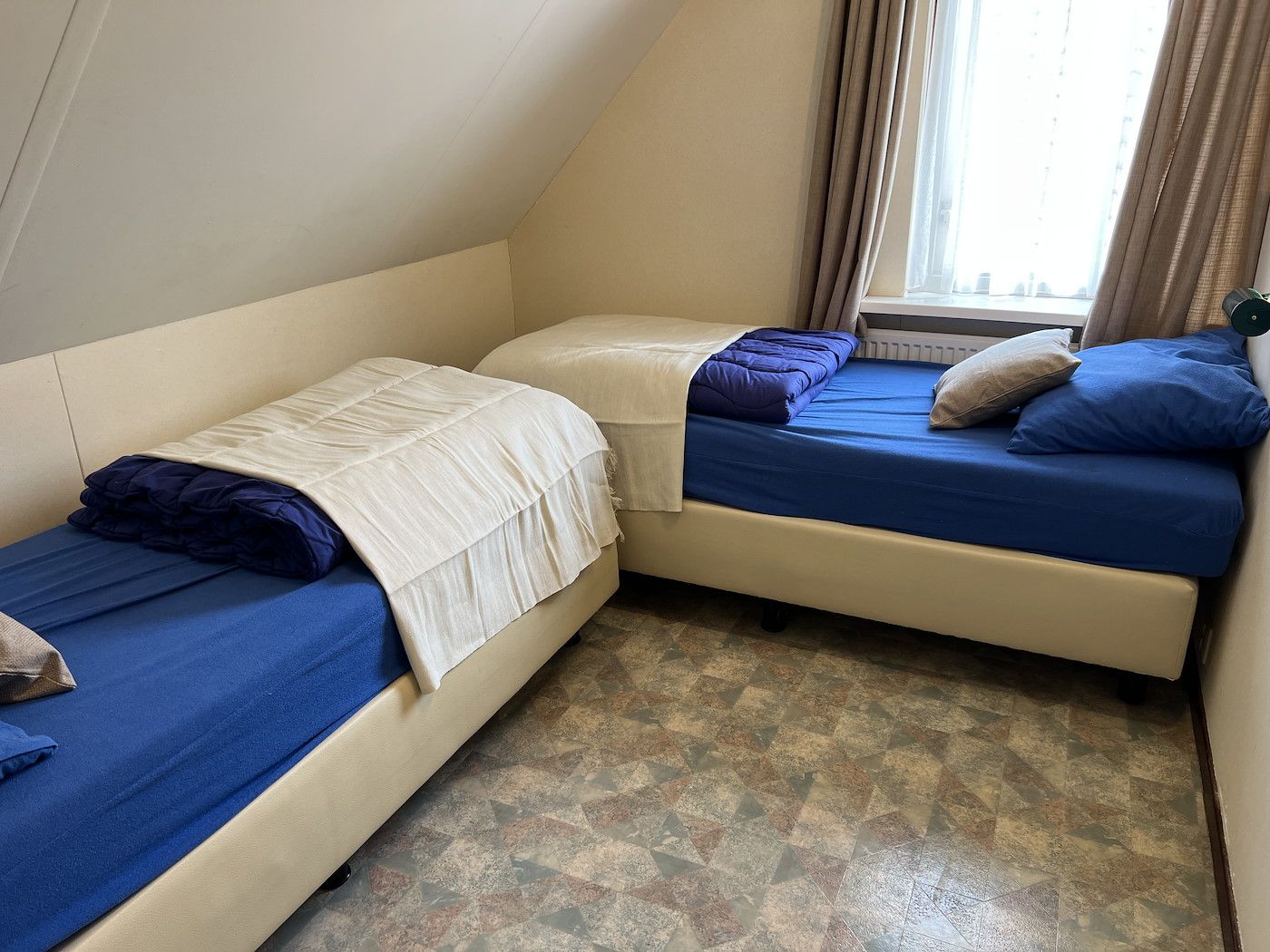 Schlafzimmer mit zwei Einzelbetten in Koetshuis 2, De Koog, Texel.