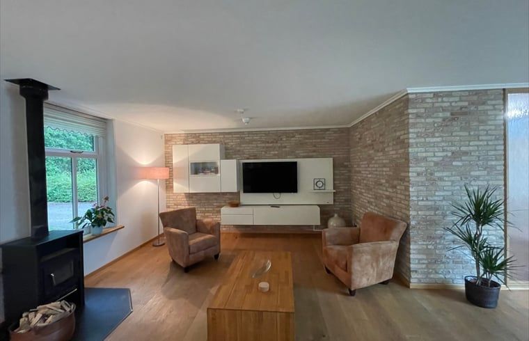 Modern living room with flat screen in Cottage in Den Burg, Texel, ideal for family gatherings.