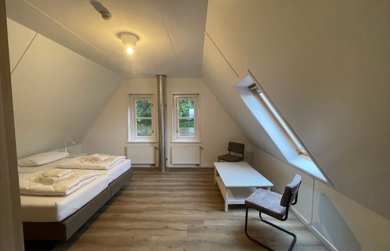 Attractive attic room in cottage in Den Burg, Texel with skylights and comfortable beds.