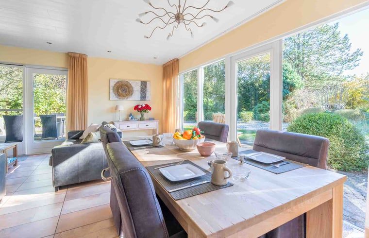 Esszimmer des Cottage in Den Burg, Texel, mit Blick auf den Garten, ideal fuer gemuetliche Mahlzeiten.