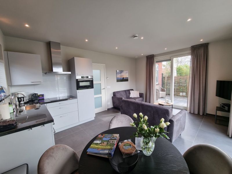 Modern kitchen and living room in Schoonoordsingel 29a, vacation home in Den Burg, Texel.