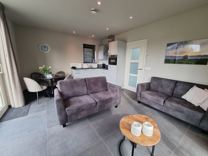 Comfortable sitting area in Schoonoordsingel 29a, vacation home in Den Burg, Texel, ideal for relaxation.