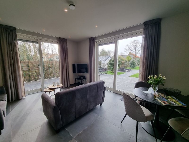 Bright living room with terrace view in vacation home Schoonoordsingel 29a, Den Burg, Texel.