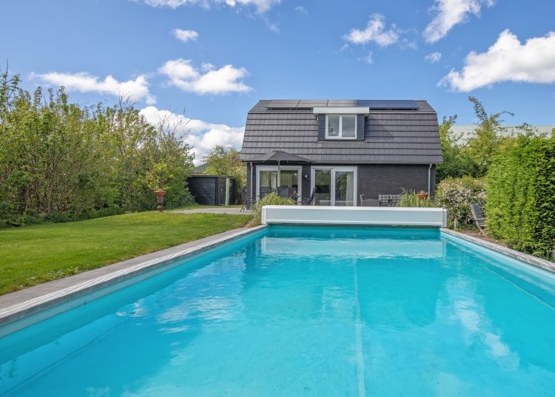 Refreshing pool at Villa 3C, Den Burg, Texel, surrounded by greenery, ultimate vacation home on the Wadden Islands.