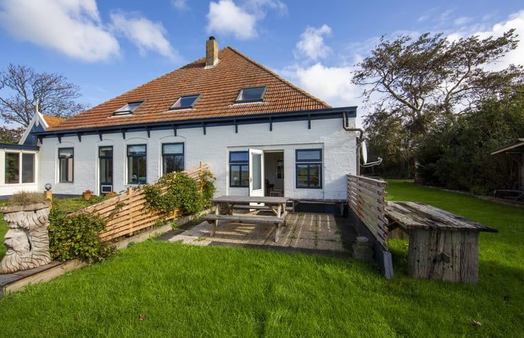 Backyard of Holiday home in Oosterend, Texel with terrace. Spacious vacation home on the Wadden Islands.