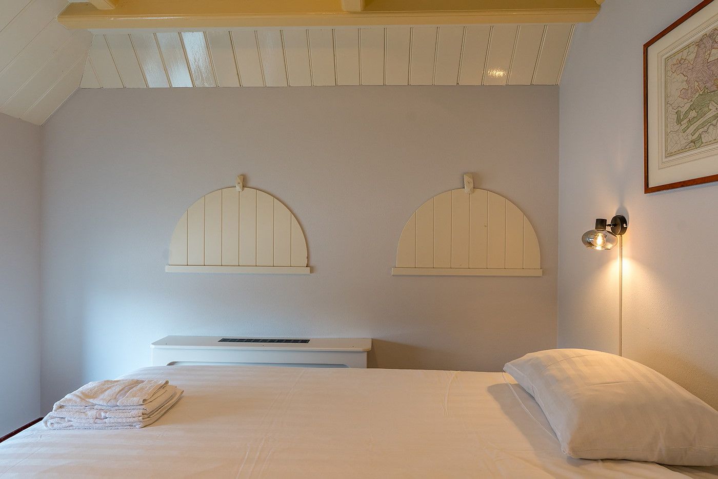 Bedroom with unique wall decoration in Zilverling vacation home on Texel.