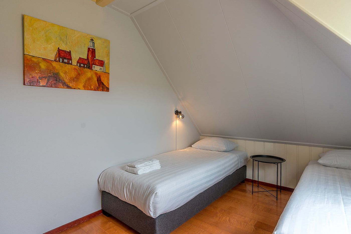 Cozy bedroom with two single beds in Zilverling vacation home, Texel.