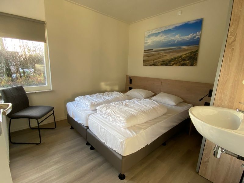 Comfortable bedroom in vacation home Vuurtoren, Oosterend, Texel with double bed.