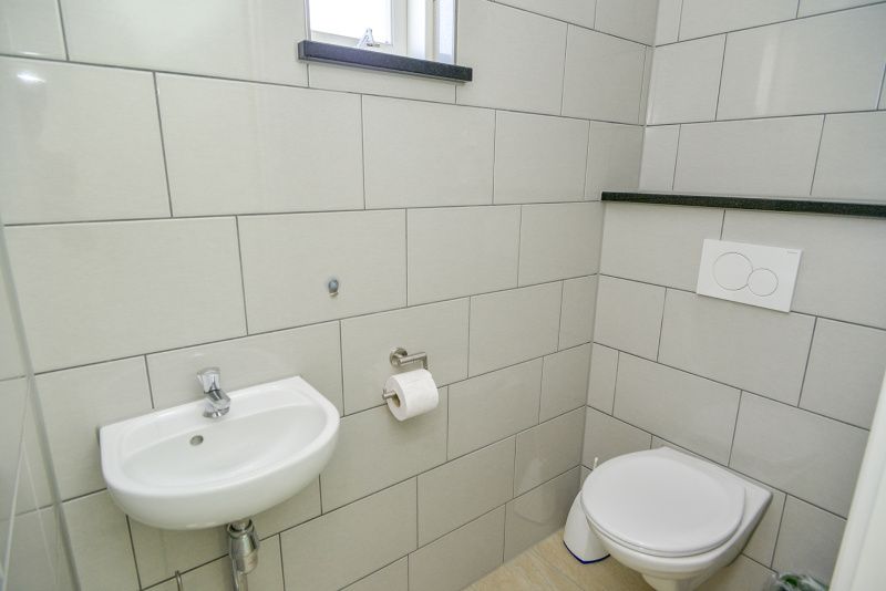 Badkamer in Slufterbungalows 362, Bungalowpark Slufteroord, Texel met strakke tegelafwerking en sanitair.