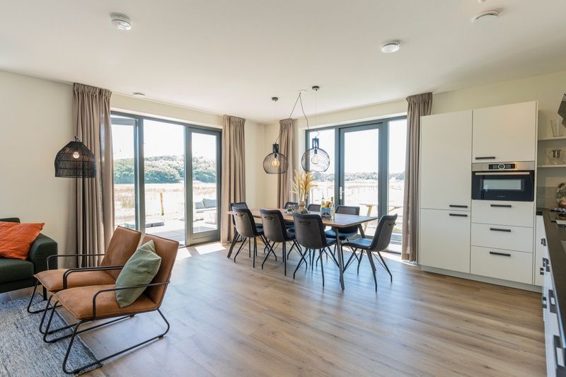 Bright interior of Holiday Home 2 in De Dennen, Texel with modern dining area and kitchen.