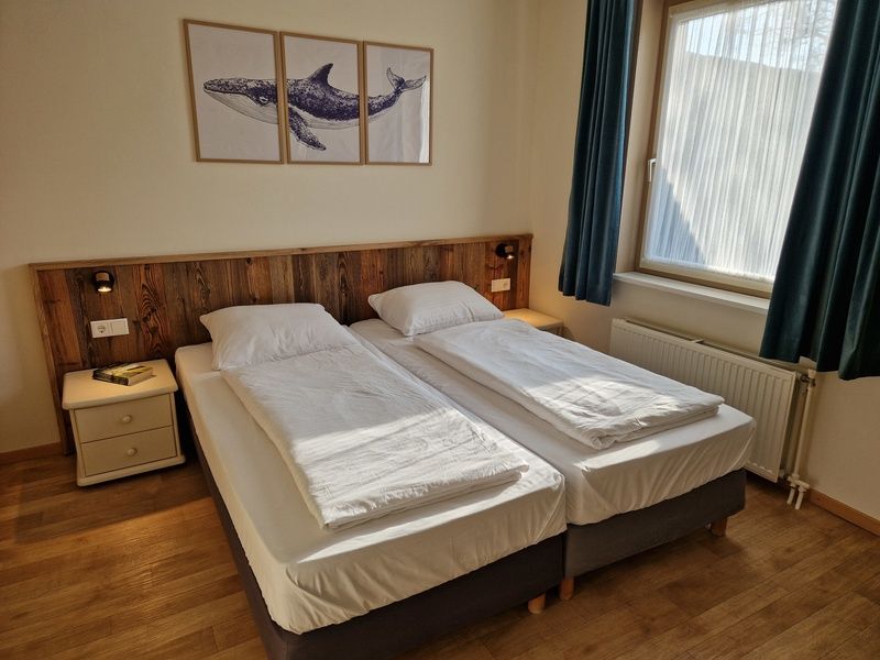 Restful bedroom in Bungalowpark Uterste Coogh - Bungalow 116, De Dennen, Texel with comfortable beds.