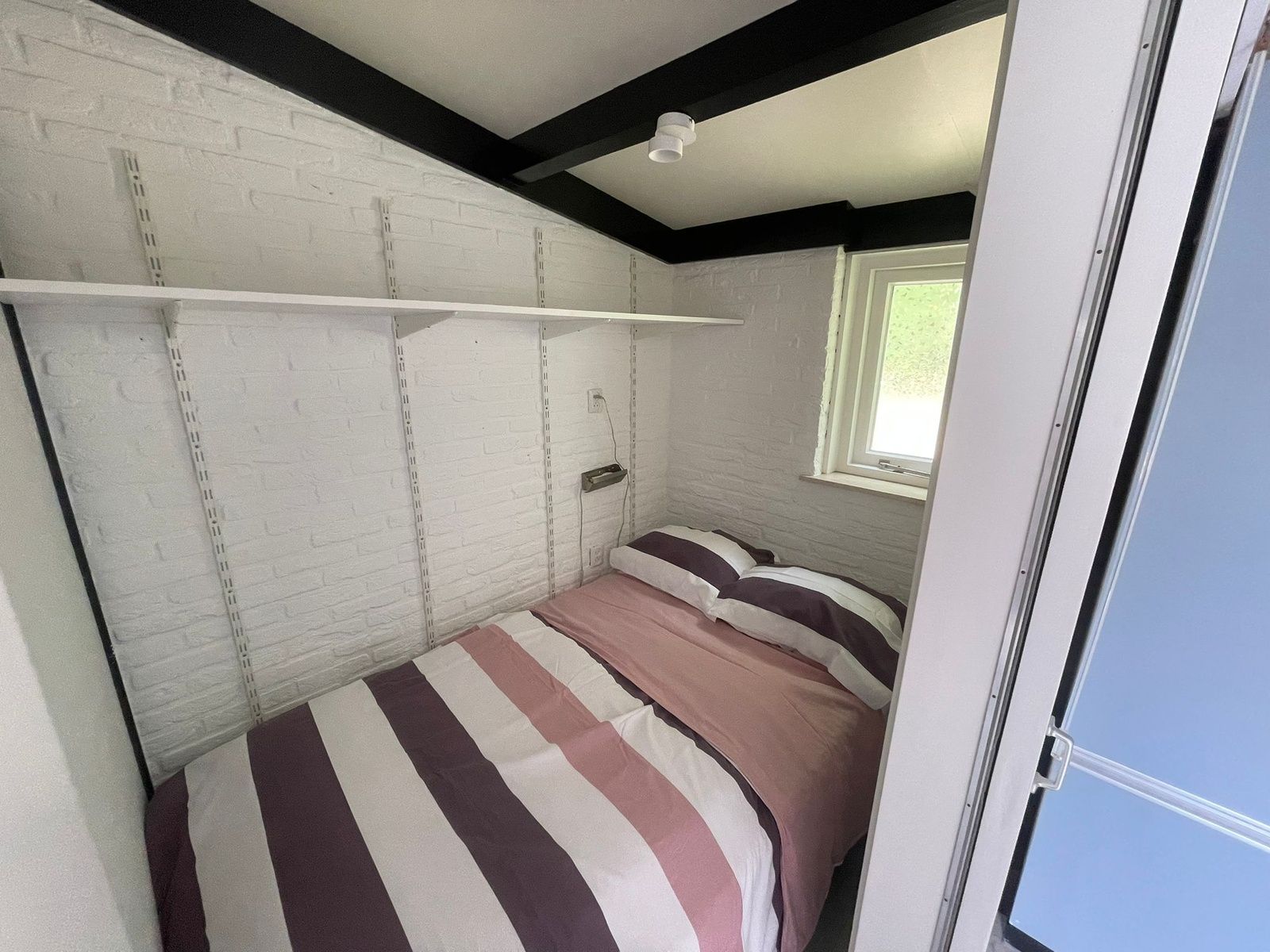 Bedroom in Wollewei vacation home, De Dennen, Texel, with comfortable double bed.