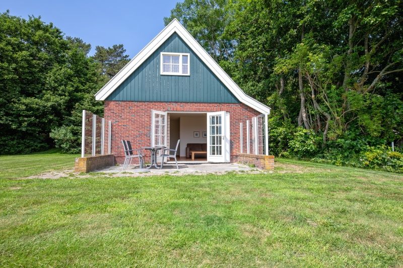 Front view of 't Mienthuis - De Jonker, vacation home in De Dennen, Texel with patio, ideal for outdoor activities on the Wadden Islands.