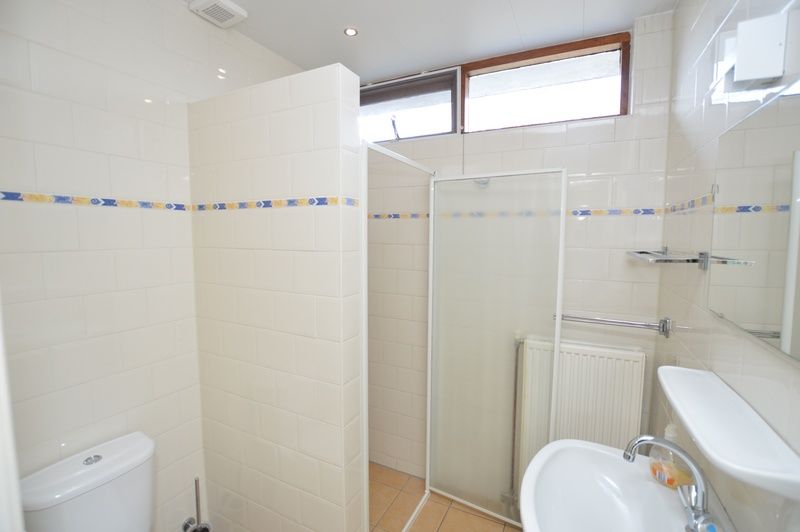 Fresh bathroom in Holiday home de Parel 204, De Dennen, Texel with shower and sink.