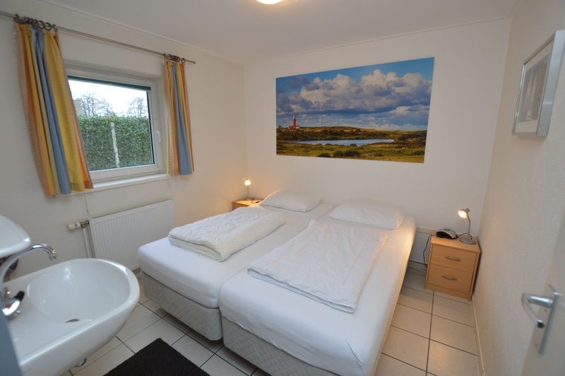 Schlafzimmer mit Doppelbett im Ferienhaus de Parel 194, De Dennen, Texel fuer hoechsten Komfort.