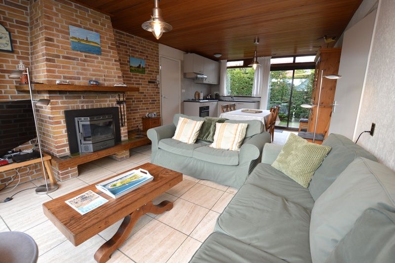 Authentic fireplace in Holiday home de Parel 258, Texel, offers warmth and atmosphere.