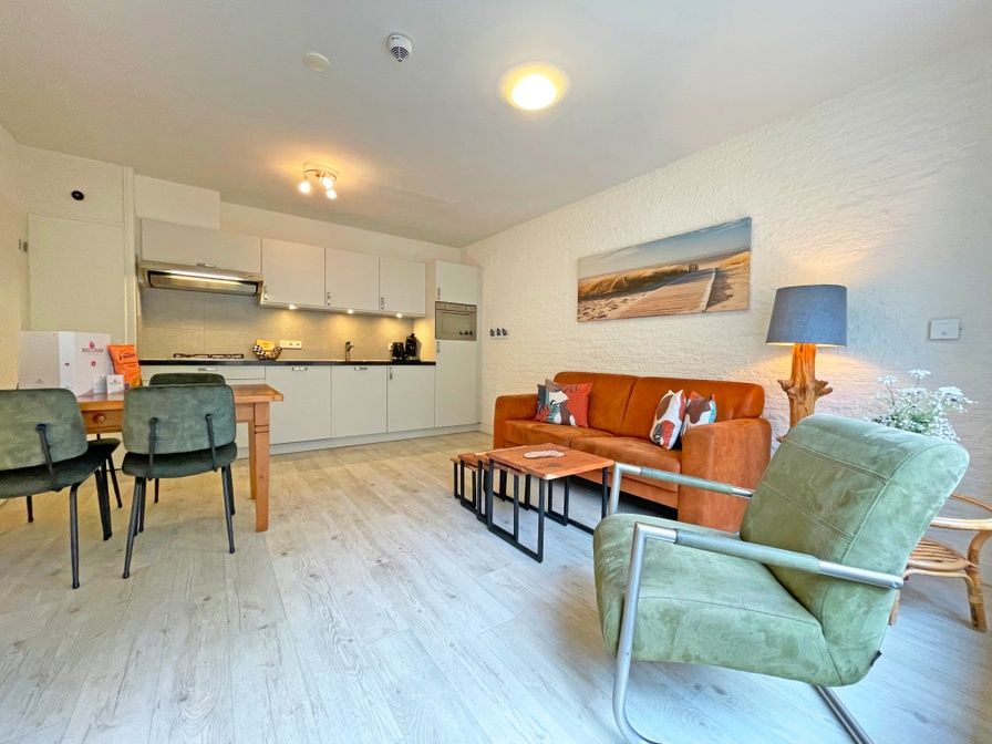 Spacious living room in Apartment Bos en Duin 08, De Dennen, Texel, with modern kitchen and comfortable seating area.