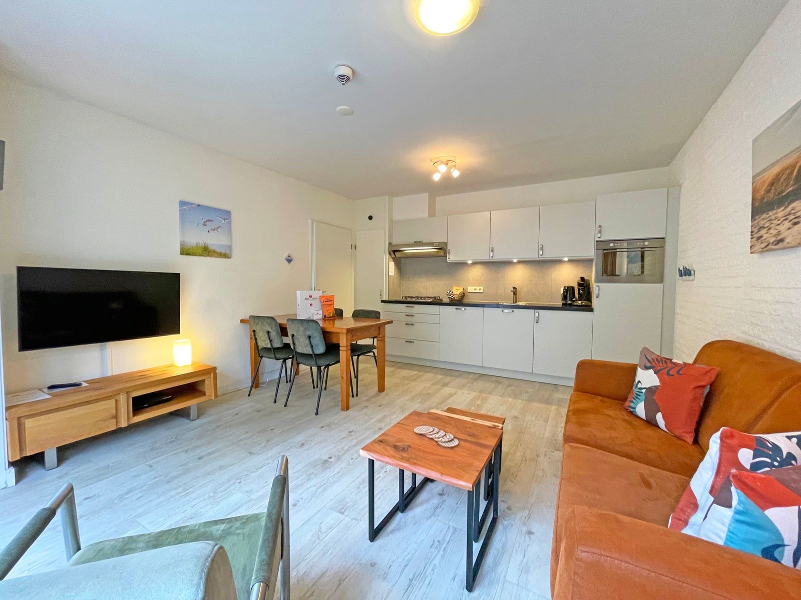 Bright living room of Apartment Bos en Duin 08, De Dennen, Texel, with access to nature.