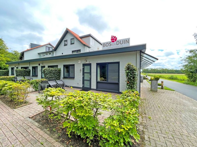 Exterior of Apartment Bos en Duin 04, De Dennen, Texel, surrounded by green nature and tranquility.