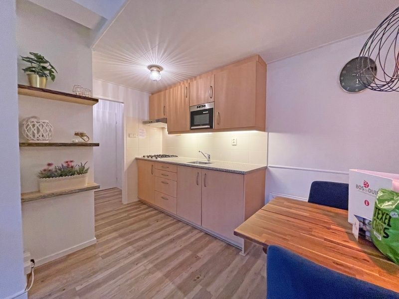 Comfortable double bedroom in Apartment Bos en Duin 27, De Dennen, Texel with a view of nature.