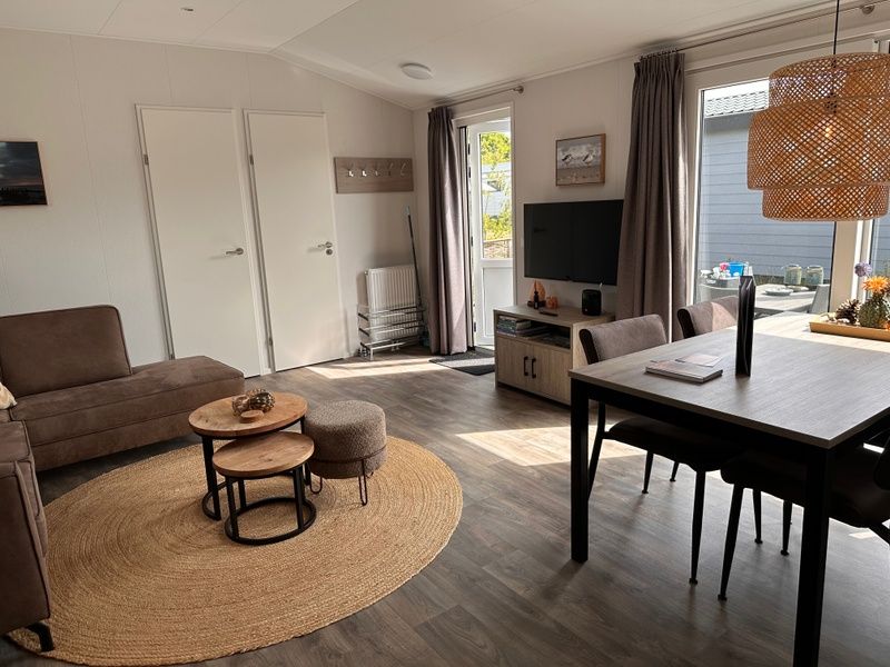 Spacious living room in Chalet Wulk, Vakantiepark de Bremakker, Texel, with access to the terrace in De Dennen.