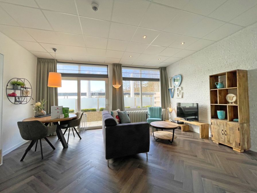 Apartment Bos en Duin 02 in De Dennen, Texel offers a spacious living room with modern interior and plenty of natural light.