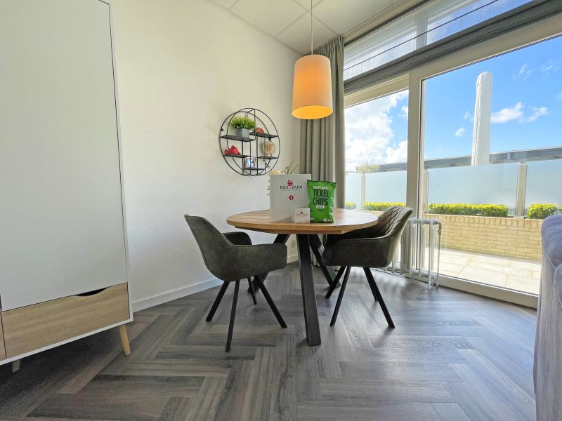 Dining area in Apartment Bos en Duin 02, Texel, overlooking the garden and space for cozy meals.