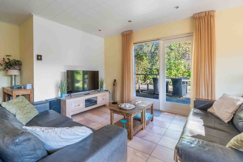 Cozy living room of Landhuis Tempelierweg 22 in Texel with comfortable seating area.