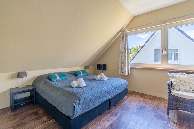 Comfortable bedroom of Landhuis Tempelierweg 22 in Texel with king-size bed.