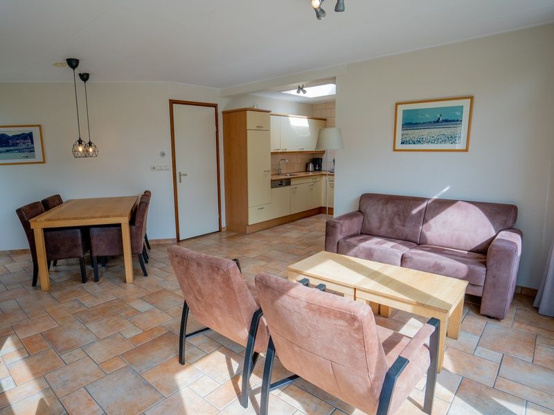 Open kitchen and dining area of Bungalow Uterste Coogh 98 in De Dennen, Texel for comfortable dining.