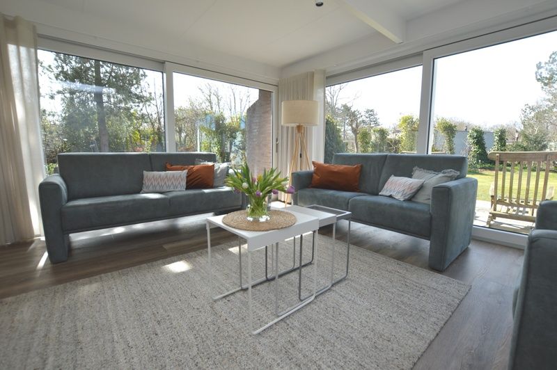 Bright living room of Bungalow Verste Coogh 58 in De Dennen, Texel overlooking the garden.
