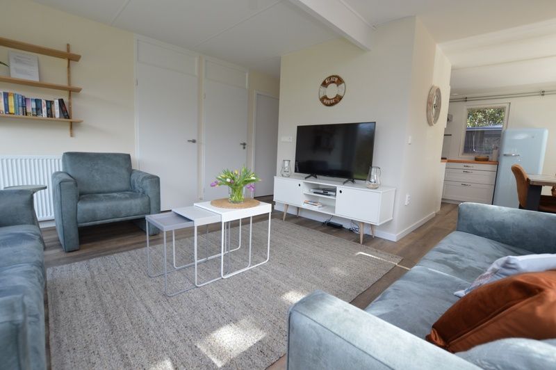 Stylish sitting room in Bungalow Verste Coogh 58, De Dennen, Texel with access to kitchen.