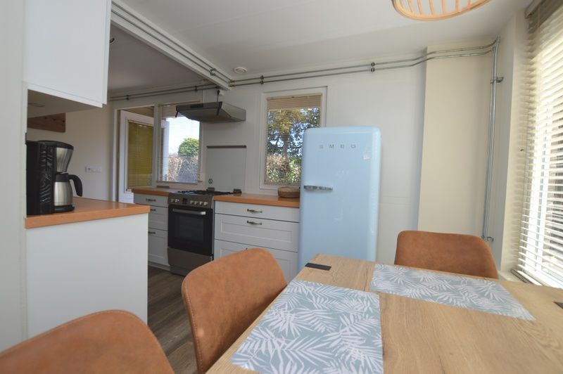 Kitchen of Bungalow Verste Coogh 58 in De Dennen, Texel with retro fridge and dining area.