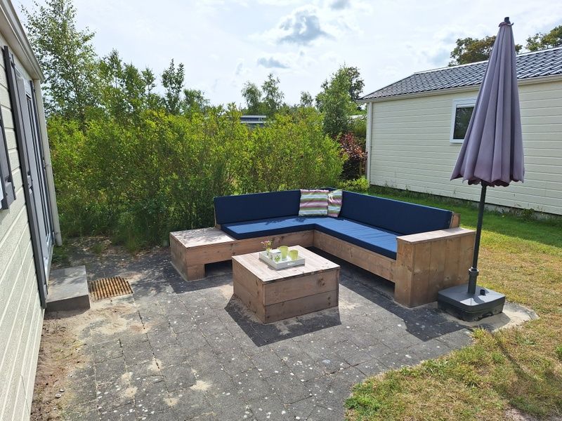 Cozy terrace with lounge sofa at Vakantiepark de Bremakker, De Dennen, Texel.