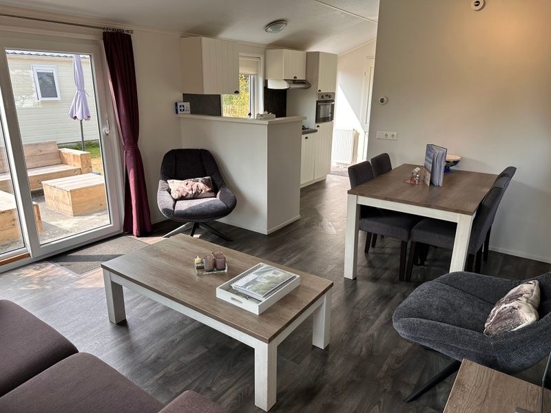Dining area and kitchen in vacation home at Vakantiepark de Bremakker, De Dennen, Texel.